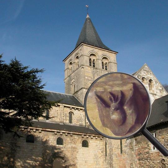 Visite Halloween - Vue sur l'église et le clocher de l'abbaye de Graville. Une loupe met en avant une sculpture en forme de chauve-souris.