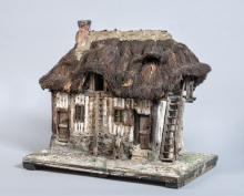 Maquette d'une chaumière, toit en chaume et mur en colombages.