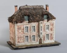 Maquette en plâtre d'un manoir de trois étages au mur de briques et toit de chaume.